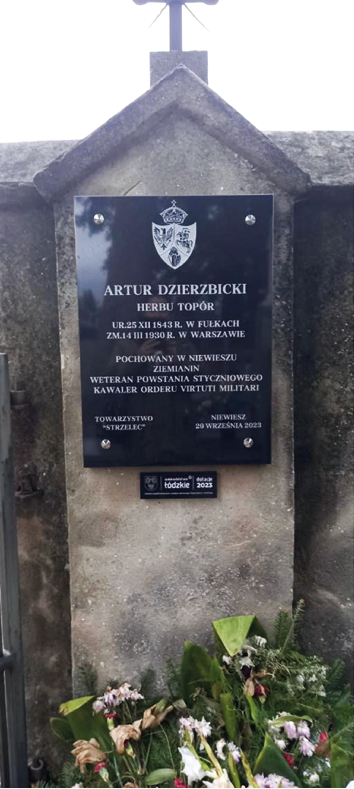 Kamienna tablica pamiątkowa Artura Dzierzbickiego na murze cmentarza w Niewieszu