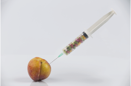 A peach, syringe, and pills evoke themes of aging, beauty, and female health. The composition metaphorically explores menopause and sexual wellness, blending medical and symbolic elements in a visually provocative way. Asset ID: 197218229. Source: Shutterstock.