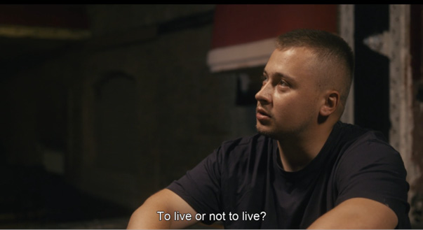 A man sitting in a dark room. To live or not to live? 