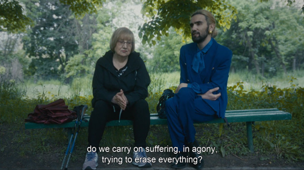 A man and woman sitting on a bench. Do we carry on suffering, in agony, trying to erase everithing?