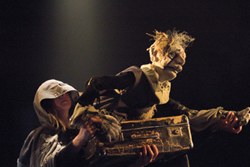 A man and a woman are standing on stage.