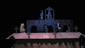 A scene with a table and a group of people.