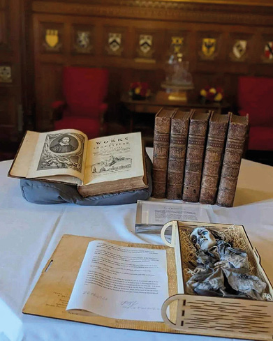 A table with a stack of books and a notebook.