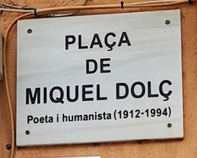 Marble street sign mounted on a wall. 