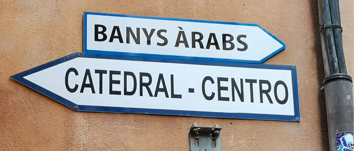 Two metal signs, one on top of the other, pointing in opposite directions. 