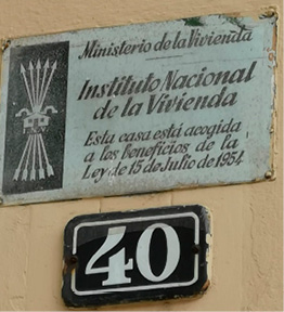 A metal plaque from the Spanish Instituto de la Vivienda, featuring the Falangist yoke and arrows, above a sign featuring the number 40. 