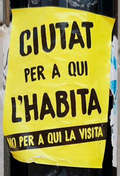 Anti-tourism protest sticker on a lamppost.  