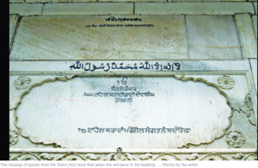 This is the interior of a Sikh temple that now functions as a school for Muslim students. Aspects of Islam are incorporated without erasing the Sikh religious invocations. 