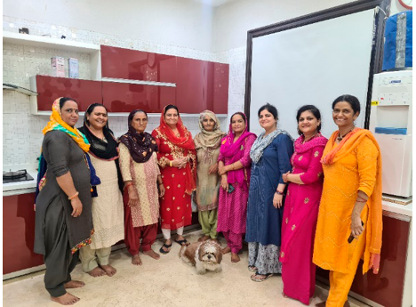 A group of nine Haryanvi women in traditional Haryanvi attire in Gurugram, smiling and posing for a photo.